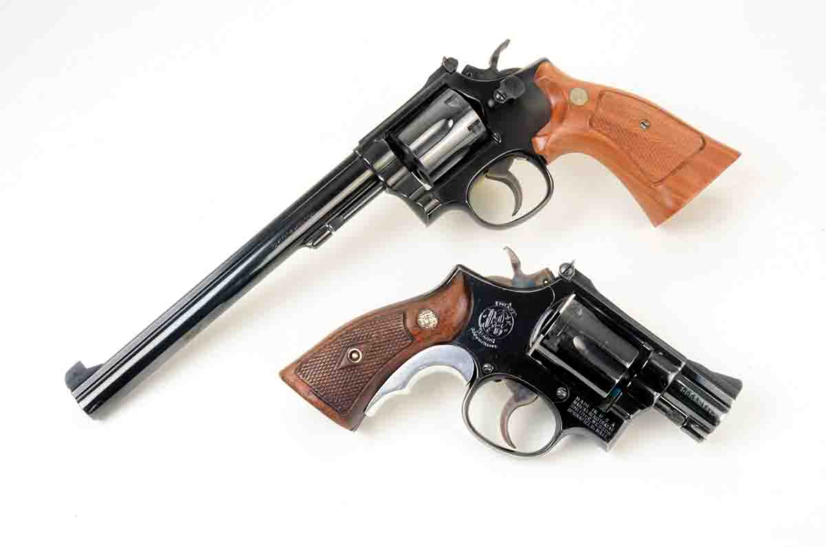 The long and short of Smith & Wesson .38 Special revolvers. At top is a Model 14 (aka K38) with an 83⁄8-inch barrel. Below it is a Model 15 (aka Combat Masterpiece) with a 17⁄8-inch barrel.